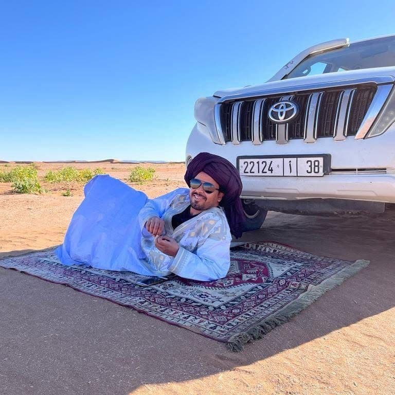 Travel guide on rug in the desert in Morocco